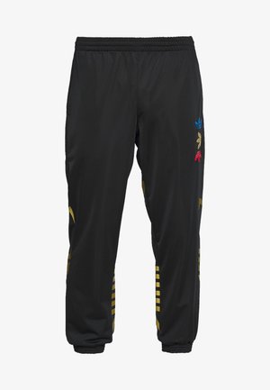 Pantalon de sport noir avec taille et poignets élastiques, avec logos Adidas trefoil multicolores et rayures diagonales dorées sur les jambes.