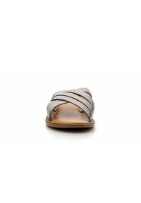 Gray cross-strap sandal featuring a smooth leather upper, a flat tan sole, and an open toe design with metallic accents.