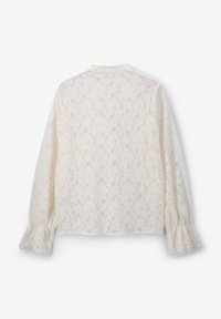 Long-sleeve white lace blouse featuring a floral pattern, ruffled cuffs, and a high collar, showcasing a delicate, textured finish.