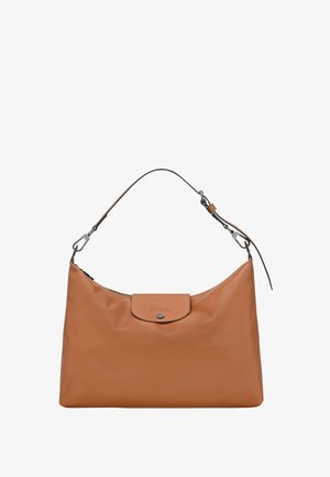 Brown leather shoulder bag with a single adjustable strap and a small flap with button closure on the front.