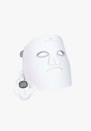 White LED facial mask with pink dotted pattern, featuring cutouts for eyes and mouth, and a detachable control unit with buttons and display.