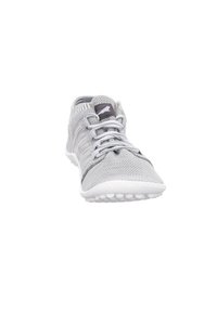 Light gray athletic shoe made of breathable mesh with a textured pattern, featuring flat laces, a cushioned sole, and white rubber accents.