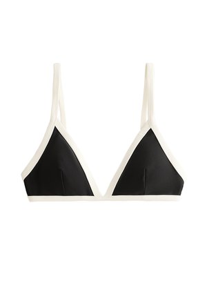 Bralette triangle noir avec bord crème. Doté de fines bretelles et d'un tissu lisse avec une texture subtile. Sans armature ni rembourrage.