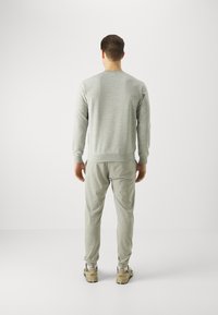 Champion ICON ELASTIC CUFF PANTS - Tepláky - grey melange