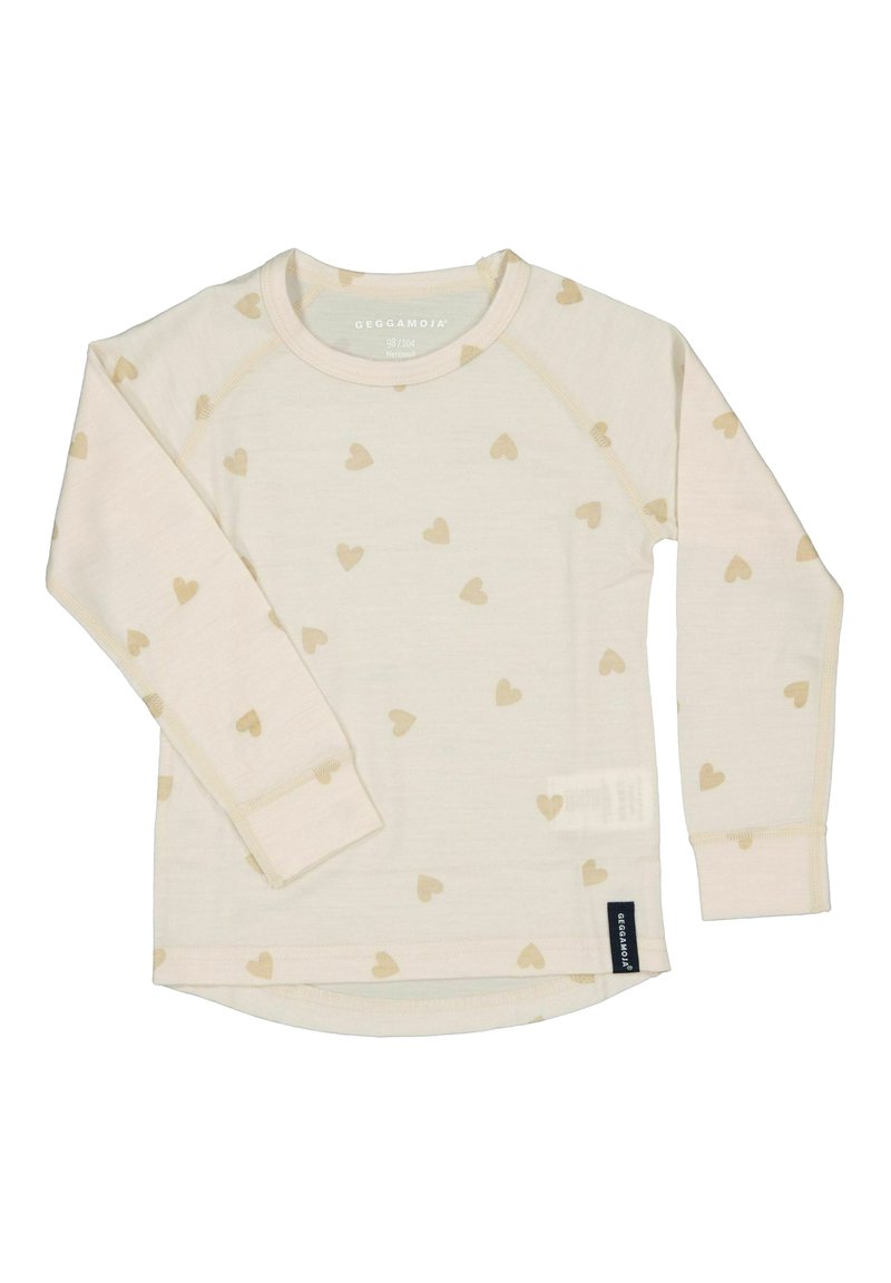 Pitkähihainen paita vaaleasta bége-kankaasta, jossa on kultaisia sydänkuvioita, pyöristetty helma ja lappu alhaalla sivussa. Pehmeä rakenne ja rento muotoilu.