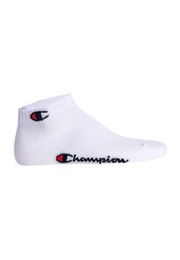 White ankle sock made of cotton blend, featuring a ribbed cuff, and black "Champions" logo with red accent on the side.