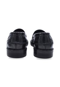 Black leather shoes with a smooth texture, rounded toe, low stacked heel, and decorative stitching detail on the back.