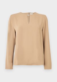 Top bej cu mâneci lungi, realizat dintr-un material neted. Prezintă un decolteu discret în V și un fermoar la spate cu un mic manșon de tragere. Design simplu, fără modele.