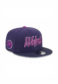 Purple snapback cap with a checkered brim, featuring bold white and pink "Wolves" embroidery and a circular logo on the side.