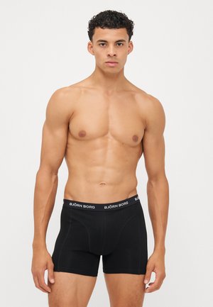 Sorte boxertruser med en myk elastisk linning merket "BJÖRN BORG." Designet for en tett passform uten synlige mønstre eller detaljer.