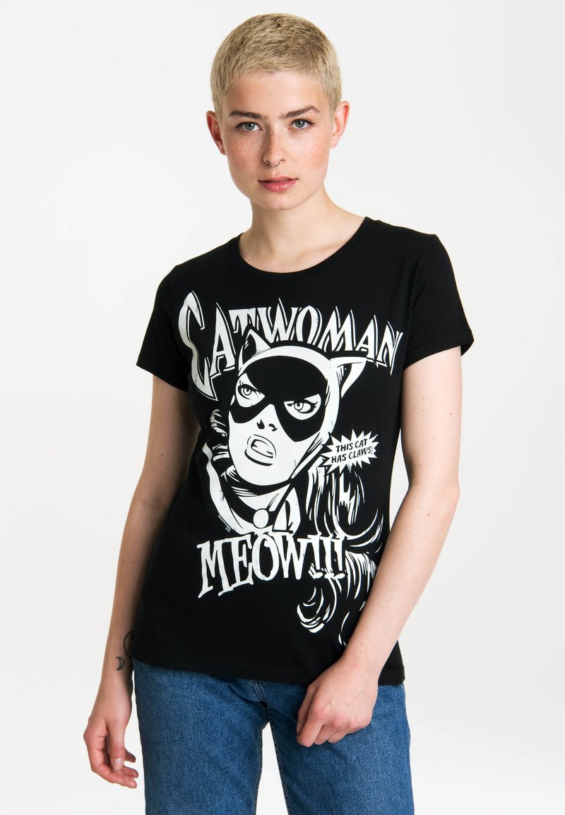 Black cotton t-shirt featuring a graphic print of a character with a mask and long hair, contrasted by white lettering and accents.