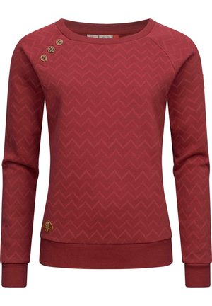Rust red long-sleeve sweatshirt with subtle chevron pattern, three decorative wooden buttons on left shoulder, and ribbed cuffs and hem.