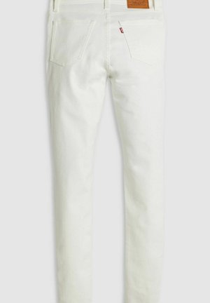 White denim jeans with a slim fit, featuring a leather back patch, two back pockets, and subtle stitching details on the seams.