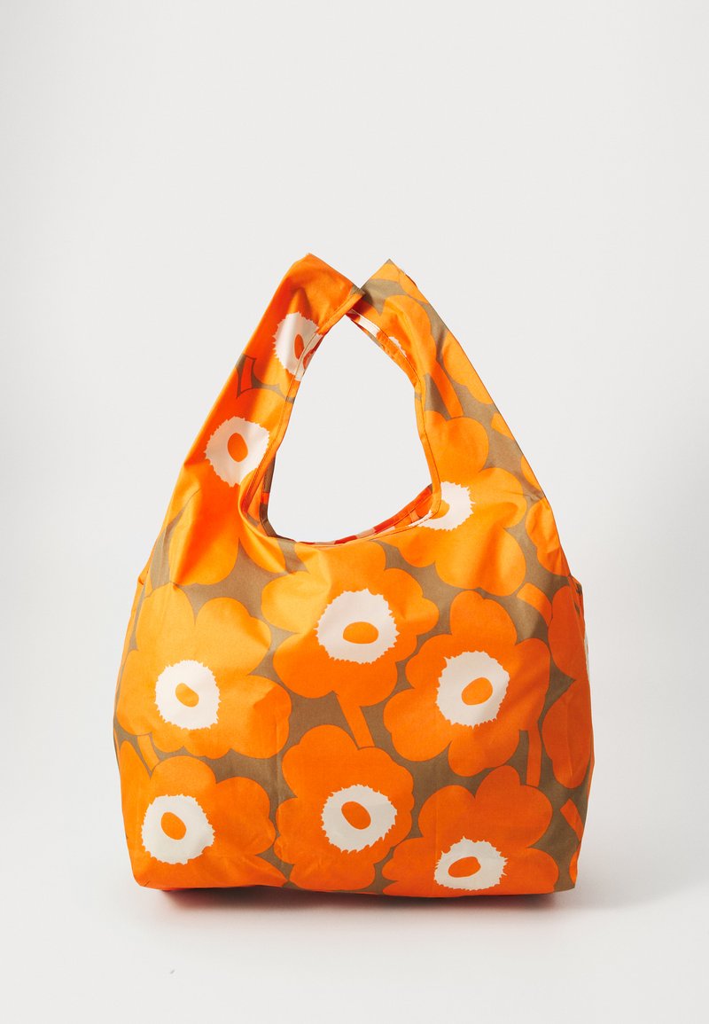 Oranssi kukallinen olkalaukku, jossa on hobo-muoto. Laukussa on suuria oransseja kukkia ja valkoisia yksityiskohtia ruskealla taustalla. Valmistettu pehmeästä kankaasta.