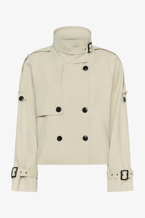 Bēšs īss trančas mētelis ar augstu sprādzes apkakli, melnām pogām, plecu epauletēm un regulējamām sprādzēm uz aprocēm.