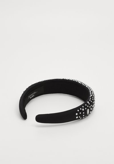 Black fabric headband embellished with silver-colored rhinestones, featuring a smooth texture and a rounded, flexible shape.
