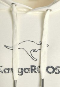 Beige Kapuzenpullover mit einem Känguru-Graphic und dem Text "Kängurus", weißen Kordeln und metallischen Aglets.