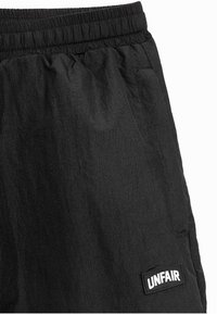 UNFAIR ATHLETICS SELECTED - Treniņtērpa apakšdaļas - black