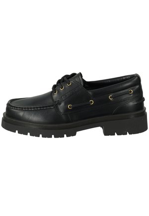 Black leather boat shoe with rounded toe, lace-up front, gold eyelets, and textured rubber sole. Features stitched detailing and a smooth finish.