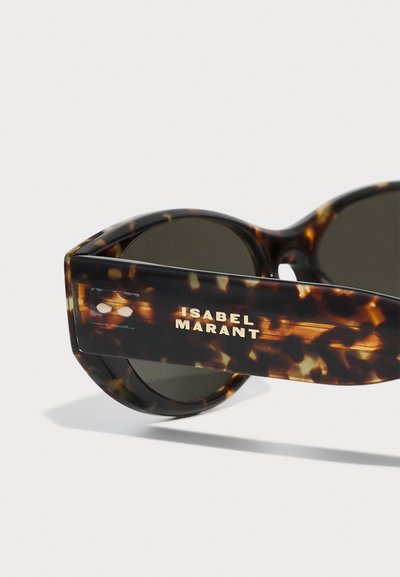 Ochelari de soare cu ramă groasă din cupru, lentile închise la culoare și branding auriu "ISABEL MARANT" pe tâmplă. Formă rotundă cu un finisaj lucios.