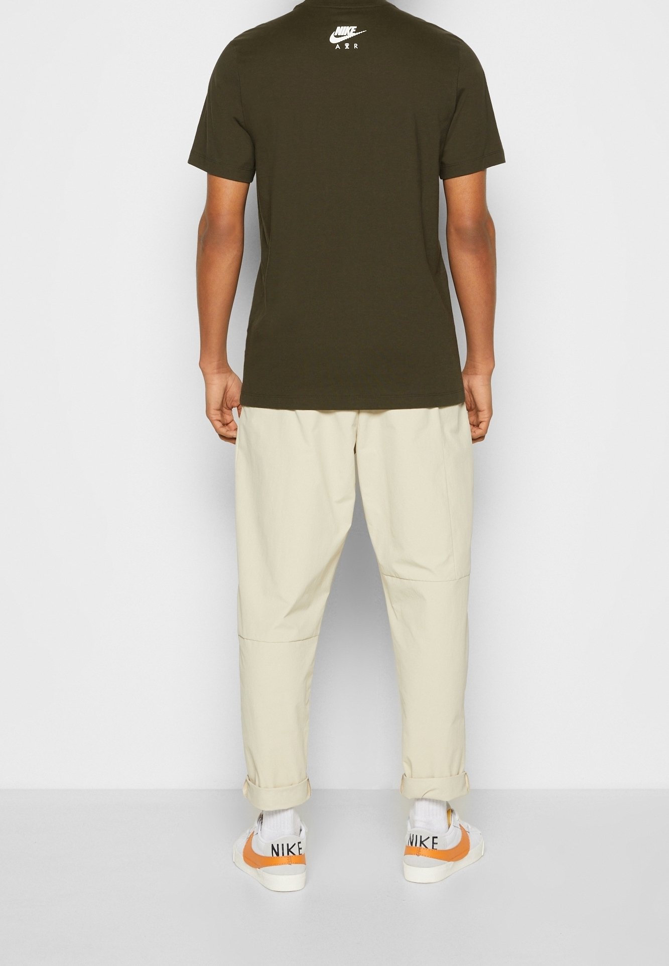 orange and olive green nike shirt