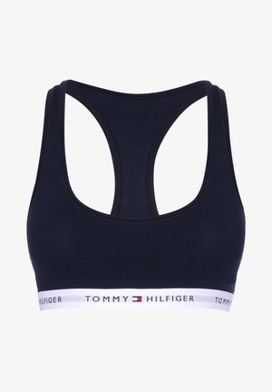 Mørkeblå sports-bh med racerback-design, laget av mykt materiale, med en hvit elastisk band med "TOMMY HILFIGER"-logo.