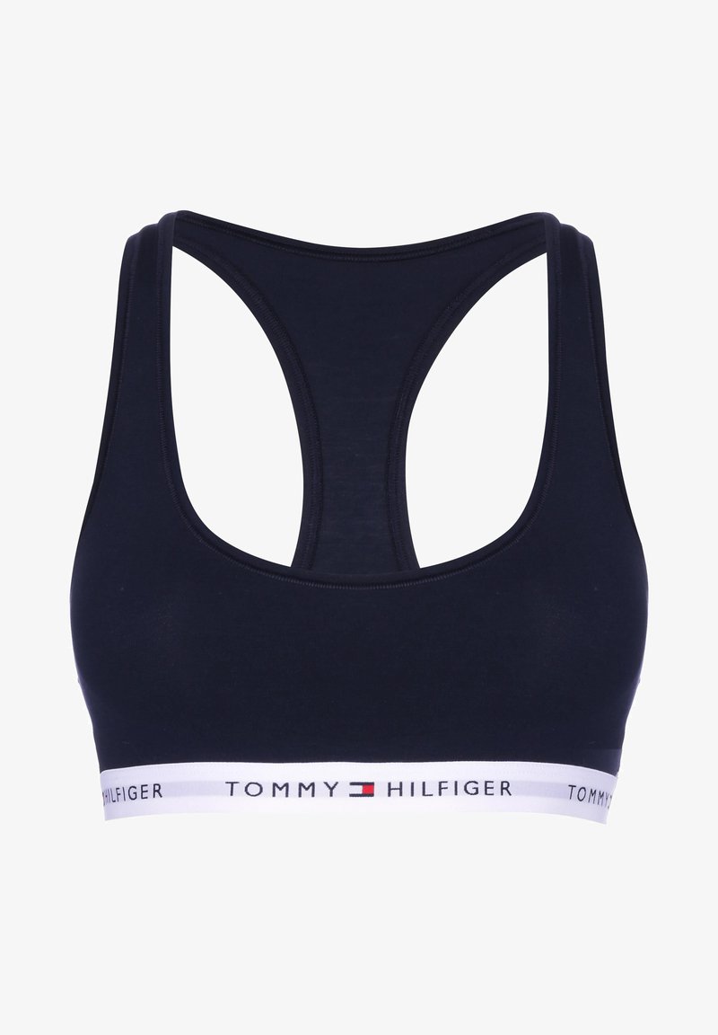 Soutien-gorge de sport bleu marine avec un design dos nageur, fabriqué dans un matériau doux, doté d'une bande élastique blanche avec le logo "TOMMY HILFIGER".