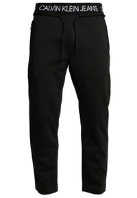 Svarta joggerbyxor i mjukt material, med elastisk midja med "CALVIN KLEIN JEANS"-logotyp och dragsko, slim fit med sidfickor.