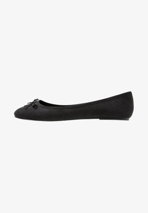Black suede ballet flat with rounded toe, small bow detail on the front, and a slim rubber sole. Smooth texture and minimalistic design.
