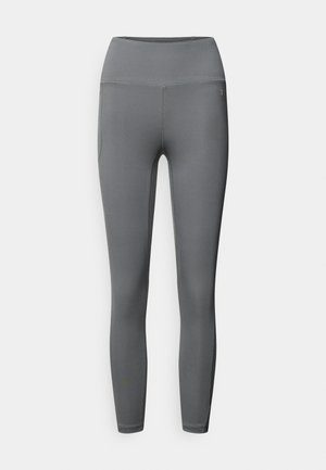 Graue Sportleggings mit hohem Bund, glattem Stoff und seitlichen Taschen. Das Design zeichnet sich durch flache Nähte und kein sichtbares Branding aus.