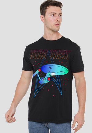 Black cotton t-shirt featuring a colorful "Star Trek" graphic with a starship and abstract design elements. Short sleeves and crew neck.