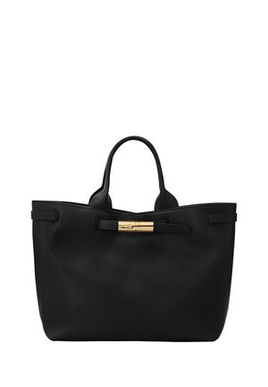 Black leather tote bag with two handles and a gold-toned metal clasp detail on a strap across the front.