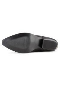 Suola di scarpa in pelle nera con superficie liscia e texture orizzontale a righe. Presenta una punta arrotondata e un tacco leggero. Marcata con '57'.