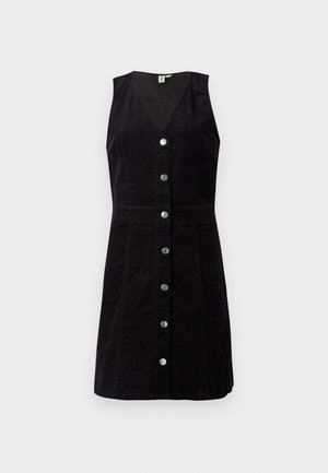 Fekete kordbársony ruha V-nyakkal, ujjatlan kialakítással és elülső gombos záródással; formázott derékkal és bővülő szoknyával rendelkezik.