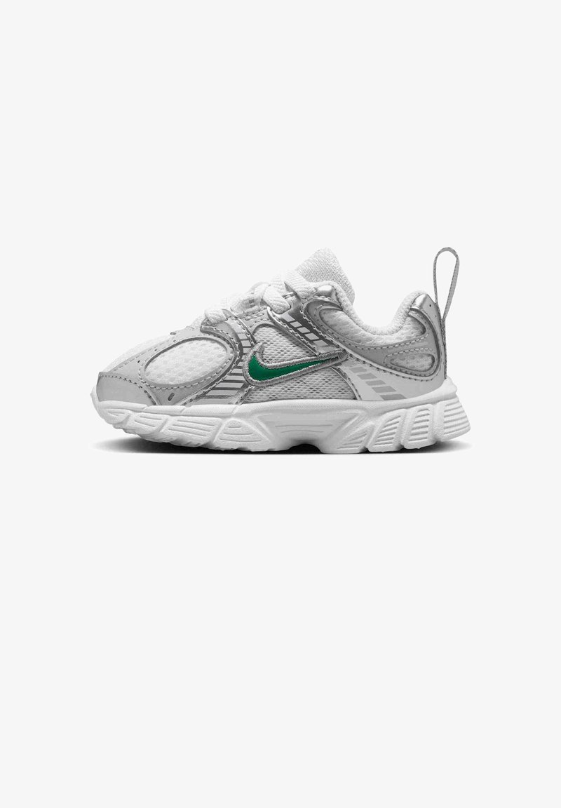 White and gray toddler sneaker with green Nike swoosh, mesh panels, textured sole, laces, and pull tab on heel, shown from side view.