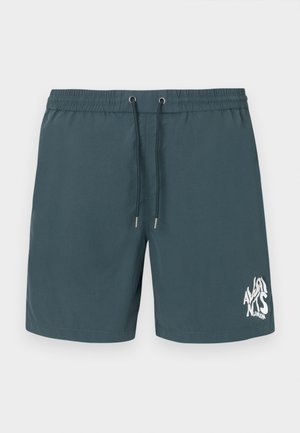 Modre kopalne hlače z elastičnim pasom, vrvico in belim grafičnim logotipom na spodnji desni strani. Gladka tekstura tkanine.