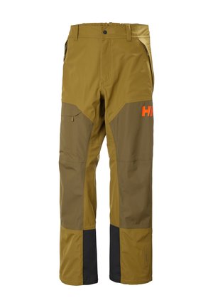 Buitenwerkbroek in bruin en mosterdkleur met versterkte knieën, ritssluitingen aan de zijkanten, riemlussen en een oranje gedeeltelijk logo op het bovenbeen.