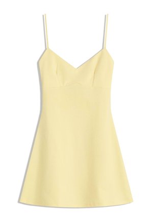 Yellow spaghetti strap dress with a V-neckline, fitted bodice, and flared skirt. Smooth texture, minimalistic design, no visible patterns.