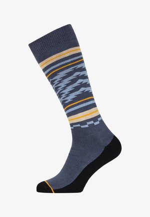 Grijze sok met een patroon van strepen in lichtblauw, geel en zwart. Het materiaal heeft een zachte textuur met een versterkte teen en hiel.