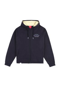 Haut de sweatshirt zippé bleu marine avec une doublure intérieure crème, présentant un petit logo coloré sur la poitrine et deux poches latérales. Matériau en coton.