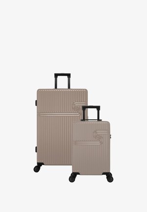 Set of two suitcases in light beige, featuring a ribbed design, telescopic handles, and four black wheels for mobility.