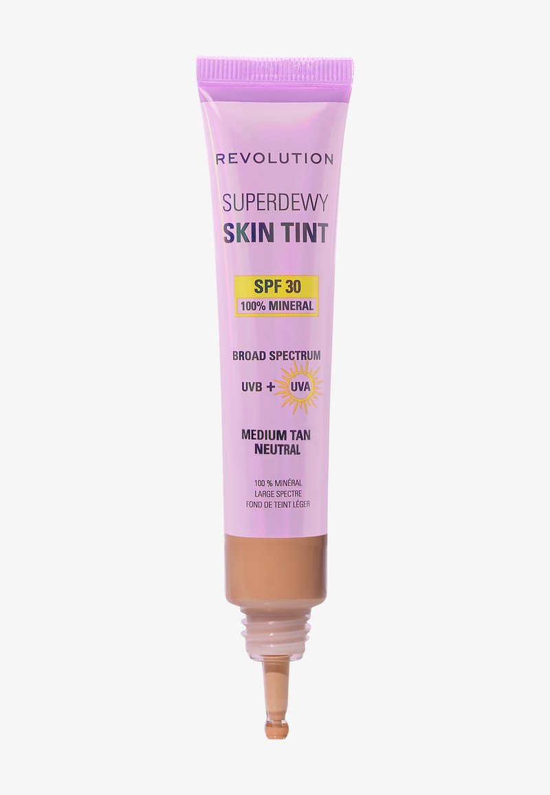 Lilla klemmetube med en spiss tut. Inneholder medium beige nøytral hudfargetone, SPF 30, merket som 100 % mineral og bredspektret solbeskyttelse.