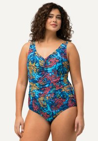 En ett-delad baddräkt i blått med ett livligt blommönster i rosa, gult och grönt. Har en djup V-ringning och rynkade detaljer.