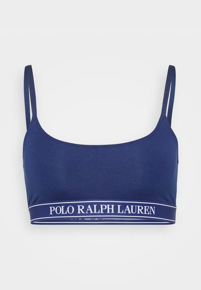 Námořnická modrá podprsenka vyrobená z žebrované látky s nastavitelnými ramínky a kontrastním bílým páskem s logem "POLO RALPH LAUREN" na spodní části.