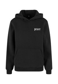 Sudadera con capucha negra de algodón, que cuenta con un bolsillo frontal y el texto "paz" en blanco en una fuente estilizada en el lado izquierdo del pecho.