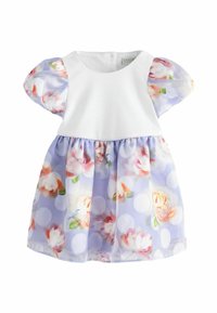 Abito bianco con corpino e maniche a sbuffo, gonna floreale lilla con pois, design stile tunica, tessuto morbido e vita arricciata.