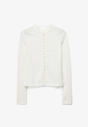 Cardigan blanc à manches longues et cropped, avec un col rond et une rangée de boutons recouverts de tissu sur le devant.