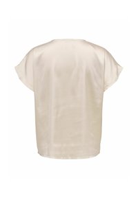 Blouse à manches courtes couleur crème vue de dos, avec un col rond et une texture de tissu lisse et légèrement brillante.