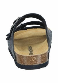 Black sandal with a cork footbed, adjustable straps, and sleek design. Textured upper with a smooth, cushioned insole for comfort.