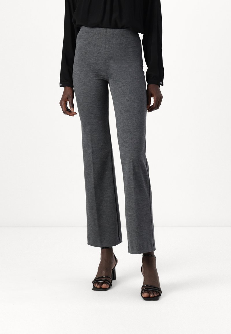 Gray, stretchy flared trousers with a high waist, featuring a smooth texture and a slight heather pattern, paired with black strappy heels.